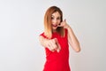 Redhead businesswoman wearing elegant red dress standing over isolated white background smiling doing talking on the telephone Royalty Free Stock Photo