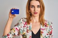 Redhead caucasian business woman holding credit card over isolated background with a confident expression on smart face thinking Royalty Free Stock Photo