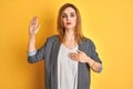 Redhead caucasian business woman over yellow isolated background Pointing to the eye watching you gesture, suspicious expression Royalty Free Stock Photo