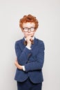 Redhead child boy in suit thinking and looking up on white background Royalty Free Stock Photo