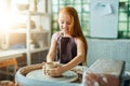 Redhead Child sculpts from clay pot. workshop on modeling on potter`s wheel. Royalty Free Stock Photo