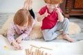 Children draw with pencils lying down and sitting on the floor