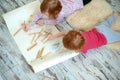 Children enthusiastically draw with colored pencils