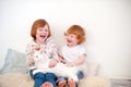 Redhead children play with a cat Royalty Free Stock Photo