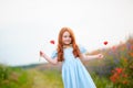 Redhead cute girl outdoors. Beautiful stylish romantic young girl with poppies Royalty Free Stock Photo