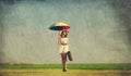 Redhead enchantress with umbrella and suitcase at spring country Royalty Free Stock Photo