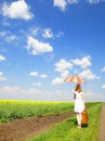 Redhead enchantress walking near rapeseed field.