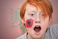 Redhead fan boy with albanian flag painted on his face Royalty Free Stock Photo