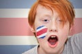 Redhead fan boy with costa rican flag painted on his face Royalty Free Stock Photo