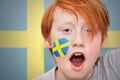 Redhead fan boy with swedish flag painted on his face Royalty Free Stock Photo