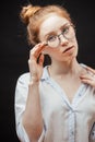 Redhead female model in glasses posing on black background Royalty Free Stock Photo