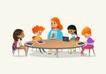 Redhead female teacher showing picture to children sitting around round table at class with laptop and tablet pc. Kids