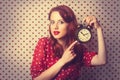 Redhead girl with alarm clock Royalty Free Stock Photo