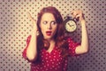 Redhead girl with alarm clock Royalty Free Stock Photo