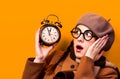 Redhead girl with alarm clock Royalty Free Stock Photo