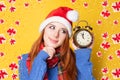 Redhead girl with alarm clock Royalty Free Stock Photo