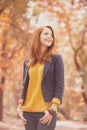 Redhead girl at autumn outdoor Royalty Free Stock Photo