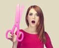 Redhead girl with big scissors Royalty Free Stock Photo