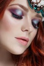 Redhead girl with bright makeup and big lashes. Mysterious fairy woman with red hair. Big eyes and colored shadows, long lashes
