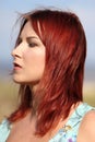 Redhead girl enjoying summer sunlight and calm wind at the sea Royalty Free Stock Photo