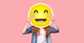 Redhead girl hiding her face behind happy emoji smile Royalty Free Stock Photo