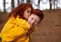 Redhead girl hugging and kissing brother Royalty Free Stock Photo