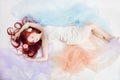 Redhead girl in light airy colored dress lies on the floor white background. Beautiful flowers in girl hair. Romantic woman Royalty Free Stock Photo