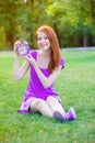 Redhead girl with litle alarm clock Royalty Free Stock Photo