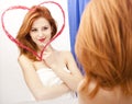 Redhead girl near mirror