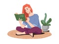 Redhead girl reading book in lotus pose on floor Royalty Free Stock Photo