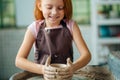 Redhead Child sculpts from clay pot. workshop on modeling on potter`s wheel. Royalty Free Stock Photo