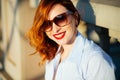 Redhead girl. She is smiling and carefree. Casual style
