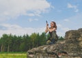 Redhead girl soldier is on one knee holding the gun