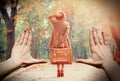 Redhead girl with suitcase in the autumn park.