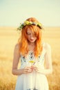 Redhead girl at summer wheat field Royalty Free Stock Photo