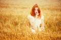 Redhead girl at summer wheat field Royalty Free Stock Photo