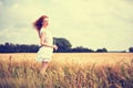 Redhead girl at summer wheat field Royalty Free Stock Photo