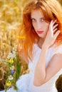 Redhead girl at summer wheat field Royalty Free Stock Photo