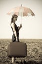 Redhead girl with umbrella at windy field. Royalty Free Stock Photo