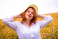 Redhead girl in wheat field Royalty Free Stock Photo