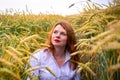 Redhead girl in wheat field Royalty Free Stock Photo