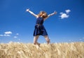 Redhead girl at wheat field in summer day. Photo with bokeh at b Royalty Free Stock Photo