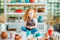 Girl wih many cups made from clay sitting in pottery studio Royalty Free Stock Photo