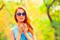 Redhead girl winh cup in the autumn park. Royalty Free Stock Photo