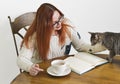 Redhead with Glasses pets her cat Royalty Free Stock Photo