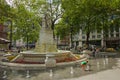 Redhead kid playing with water in a public fountain in a summer in London