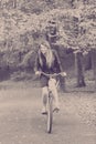 Redhead lady cycling in park. Royalty Free Stock Photo