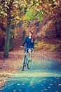 Redhead lady cycling in park. Royalty Free Stock Photo