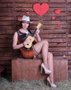 Redhead legged photomodel in minidress and  stockings with guitar  posing in studio Royalty Free Stock Photo