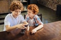 Redhead little boy listening to music with older brother Royalty Free Stock Photo